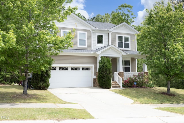 craftsman inspired home featuring covered porch, driveway, a garage, a front lawn, and a shingled roof