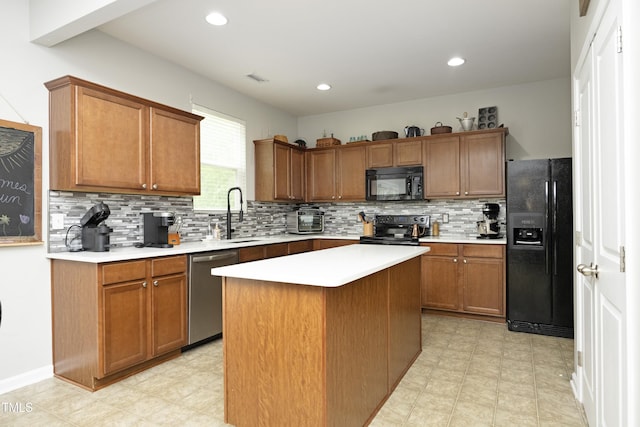 kitchen with a sink, decorative backsplash, black appliances, and light countertops