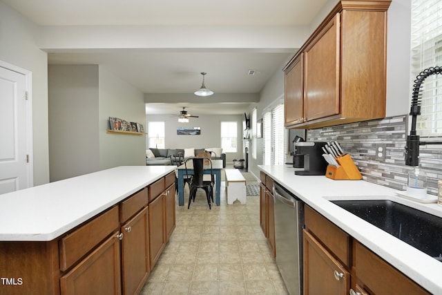 kitchen with a sink, dishwasher, light countertops, a ceiling fan, and tasteful backsplash