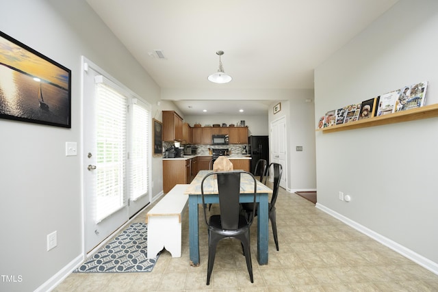 dining room with baseboards and visible vents