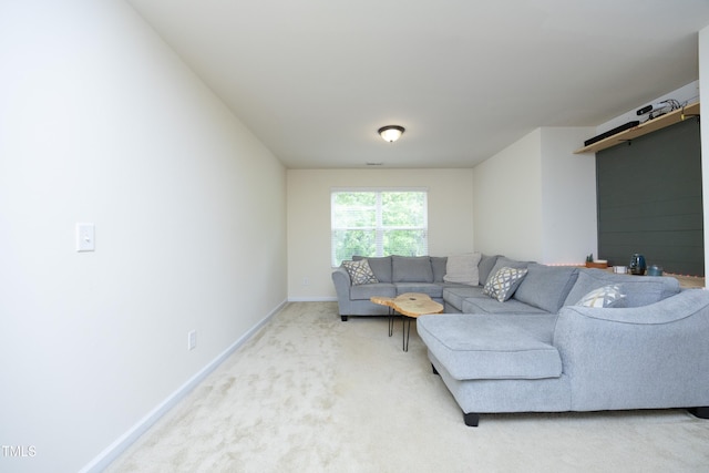 living room with baseboards and light carpet