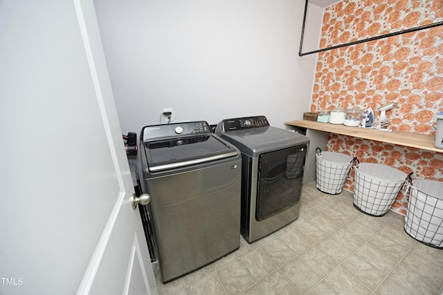 washroom featuring laundry area and washing machine and clothes dryer