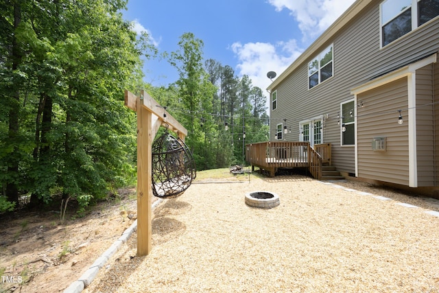 view of yard featuring a fire pit and a deck