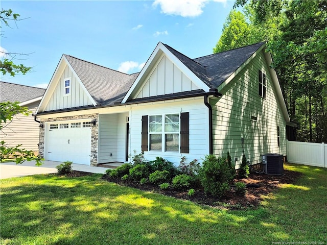 view of front of property with board and batten siding, fence, driveway, and a garage