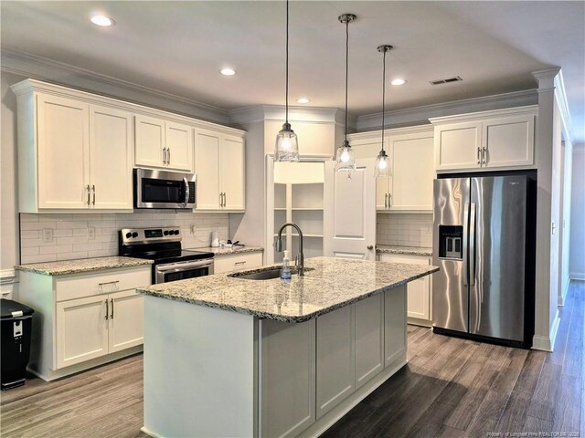 kitchen featuring a sink, appliances with stainless steel finishes, white cabinets, and wood finished floors