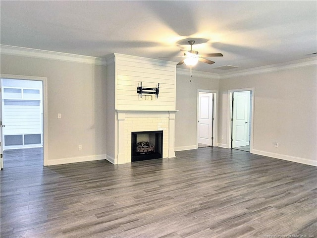 unfurnished living room with baseboards, dark wood finished floors, ceiling fan, and a large fireplace