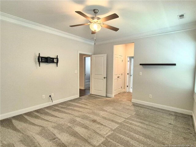 interior space featuring baseboards, ornamental molding, carpet flooring, and visible vents