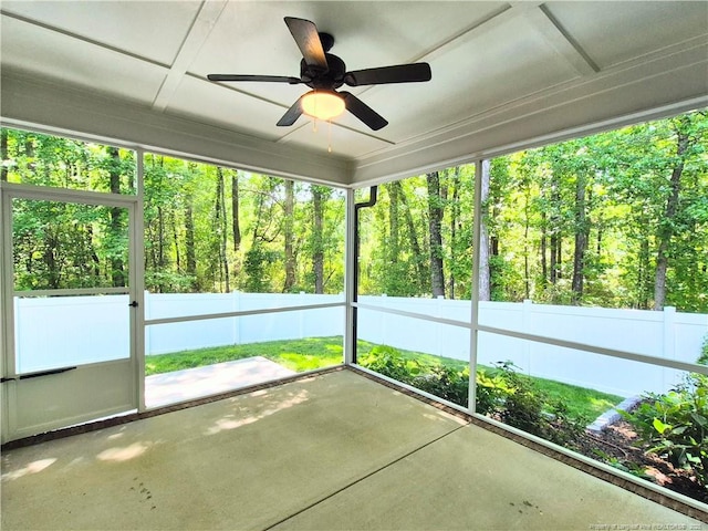 unfurnished sunroom featuring ceiling fan