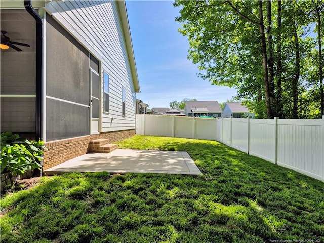 view of yard with a patio, a fenced backyard, a ceiling fan, and entry steps