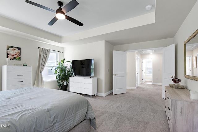 bedroom featuring a ceiling fan, baseboards, and light carpet