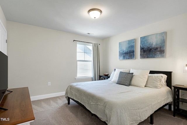 carpeted bedroom with baseboards and visible vents