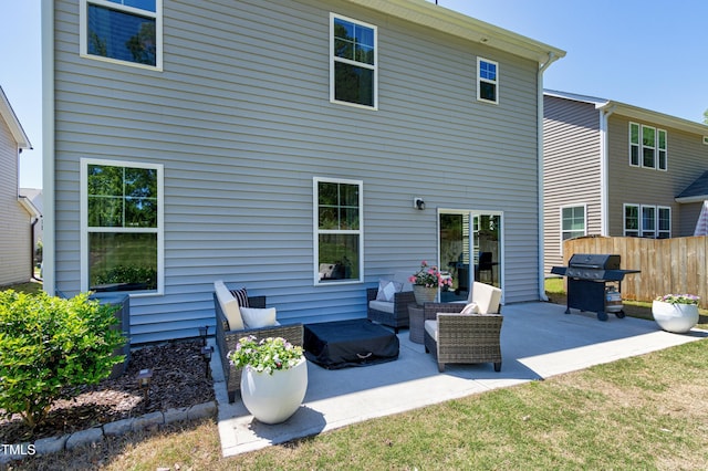 back of property featuring fence and a patio