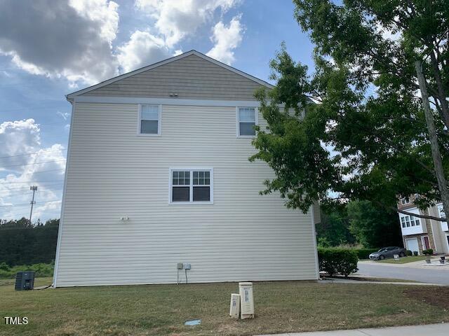 view of side of property with a lawn