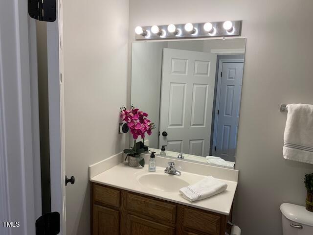 bathroom featuring toilet and vanity