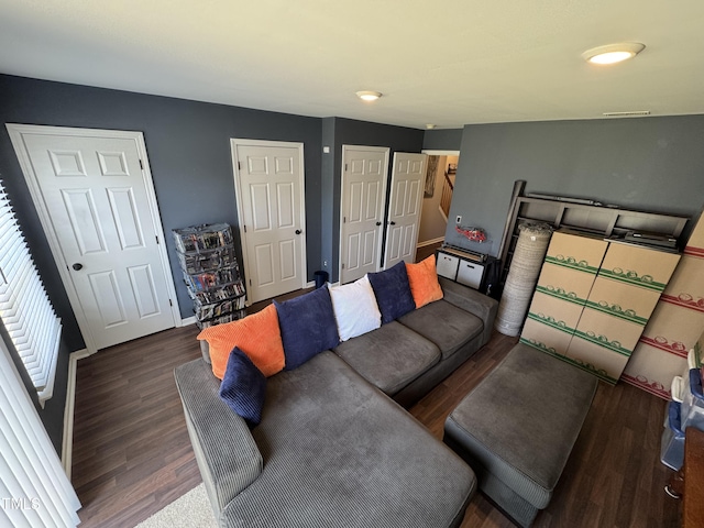living area featuring baseboards and wood finished floors