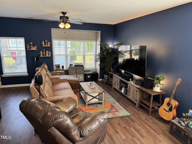 living area with baseboards, a ceiling fan, and wood finished floors