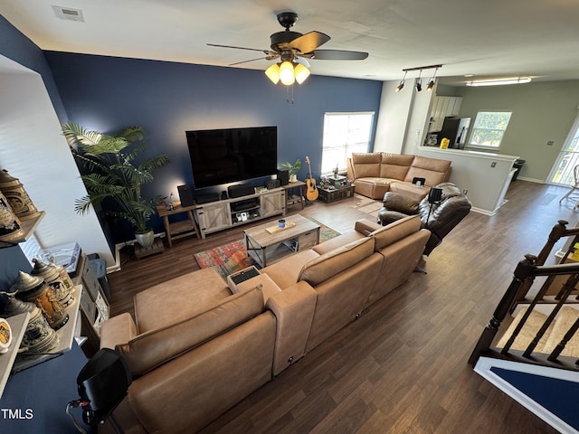 living room with a ceiling fan, baseboards, visible vents, and wood finished floors