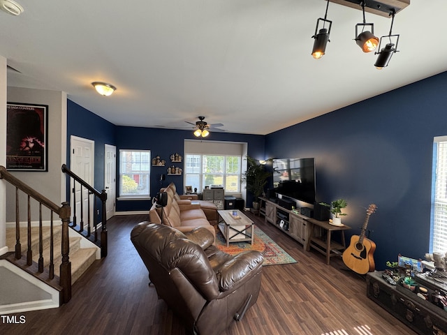 living area with stairway, ceiling fan, and wood finished floors