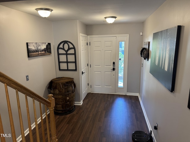 entryway featuring stairway, baseboards, and dark wood finished floors