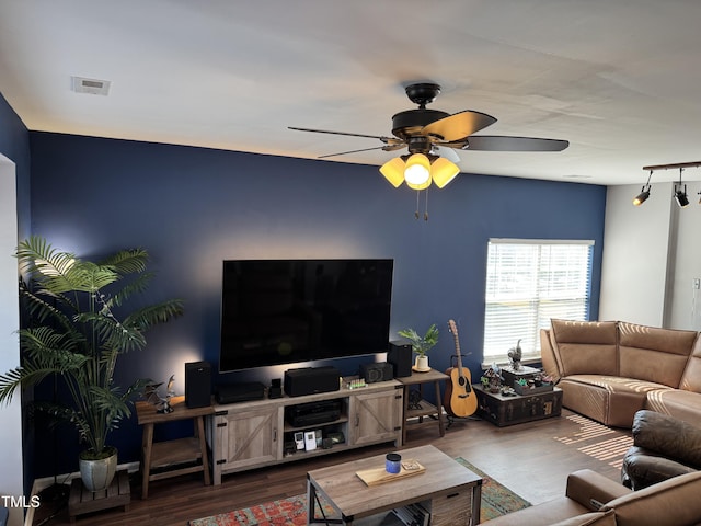 living area featuring ceiling fan, visible vents, and wood finished floors