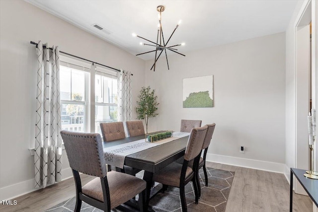 7729 Calcutta Dr, Willow Springs, NC 27592 - dining room with baseboards, visible vents, wood finished floors, and a chandelier