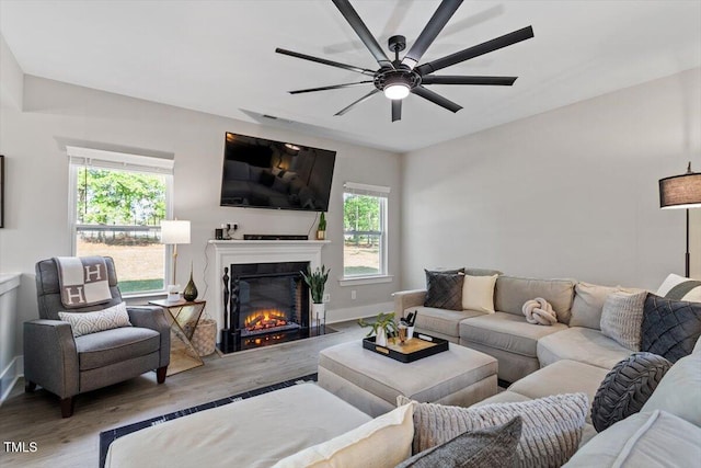 7729 Calcutta Dr, Willow Springs, NC 27592 - living room featuring baseboards, ceiling fan, a glass covered fireplace, and wood finished floors