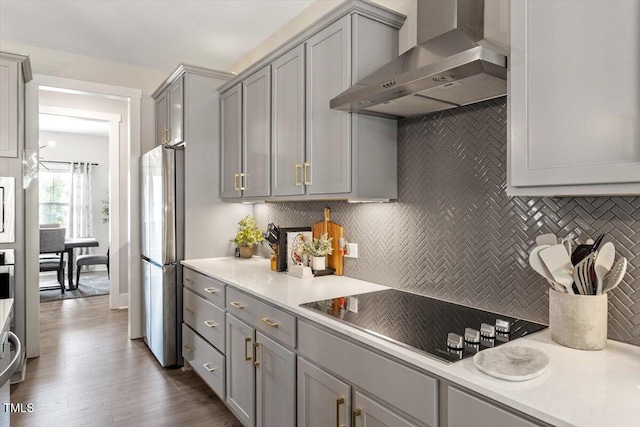 7729 Calcutta Dr, Willow Springs, NC 27592 - kitchen featuring gray cabinetry, freestanding refrigerator, black electric stovetop, and wall chimney range hood