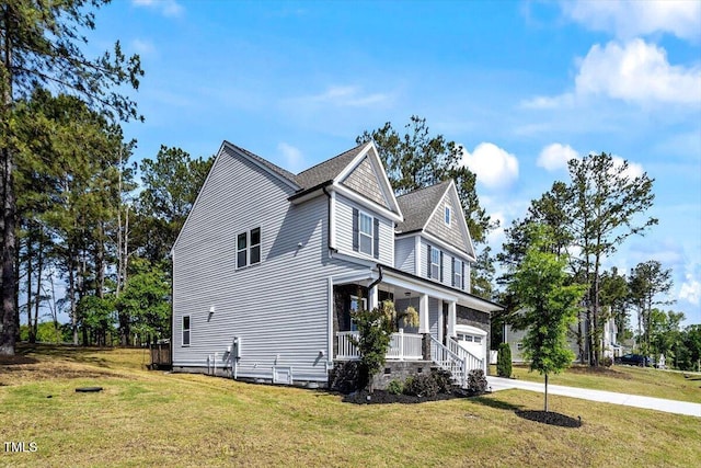 7729 Calcutta Dr, Willow Springs, NC 27592 - view of side of home featuring a lawn, a porch, driveway, and a garage