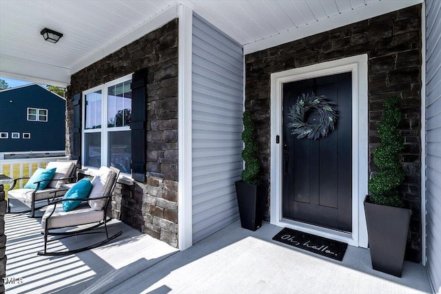 7729 Calcutta Dr, Willow Springs, NC 27592 - view of exterior entry with a porch and stone siding