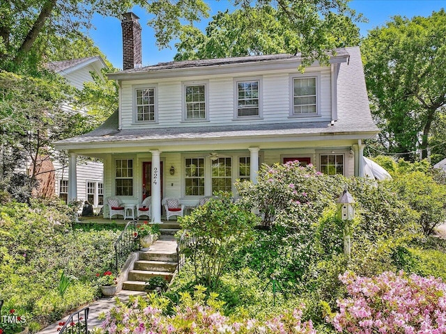 view of front of property with a chimney and a porch
