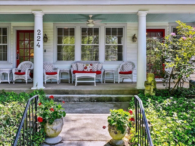 view of exterior entry featuring covered porch and ceiling fan