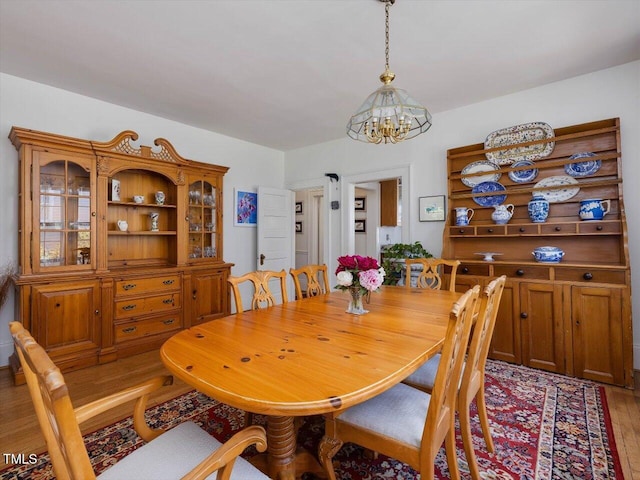 dining room featuring an inviting chandelier and light wood finished floors