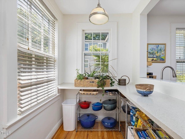 interior space with baseboards and wood finished floors