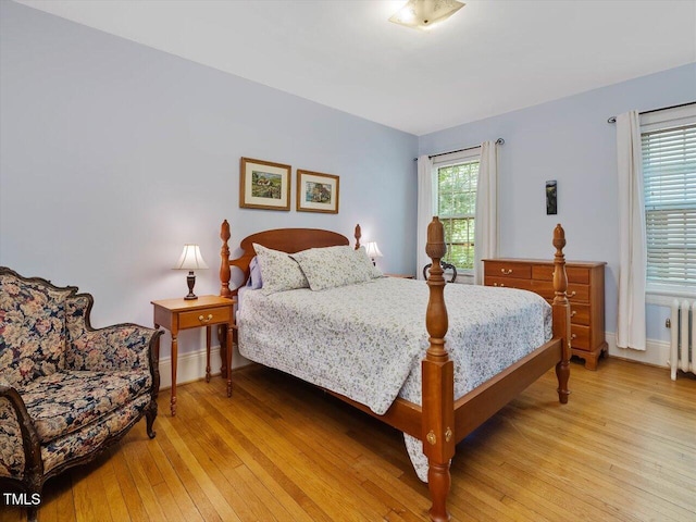 bedroom with baseboards and light wood-type flooring