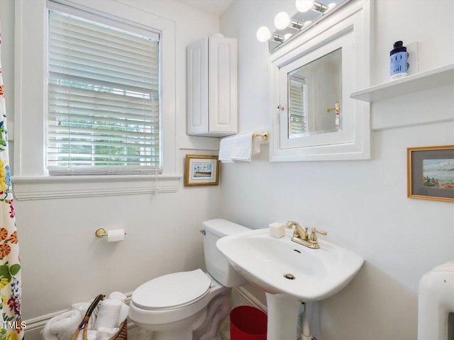 full bathroom featuring toilet and a sink