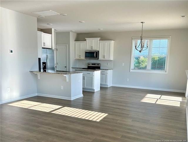 331 Brentmoor Dr, Raeford, NC 28376 - kitchen featuring white cabinets, appliances with stainless steel finishes, a breakfast bar, a peninsula, and dark wood-style floors
