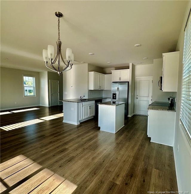 331 Brentmoor Dr, Raeford, NC 28376 - kitchen with dark countertops, a sink, a chandelier, stainless steel appliances, and open floor plan