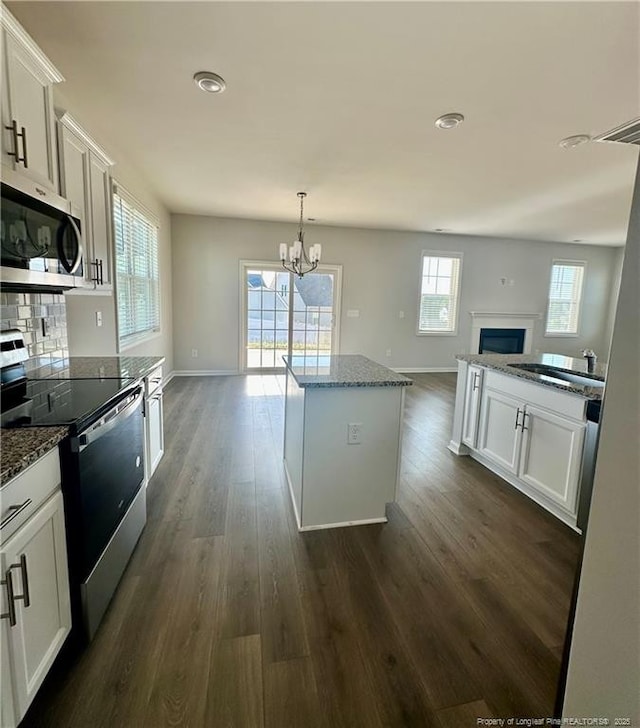 331 Brentmoor Dr, Raeford, NC 28376 - kitchen with a kitchen island, open floor plan, a chandelier, a sink, and appliances with stainless steel finishes
