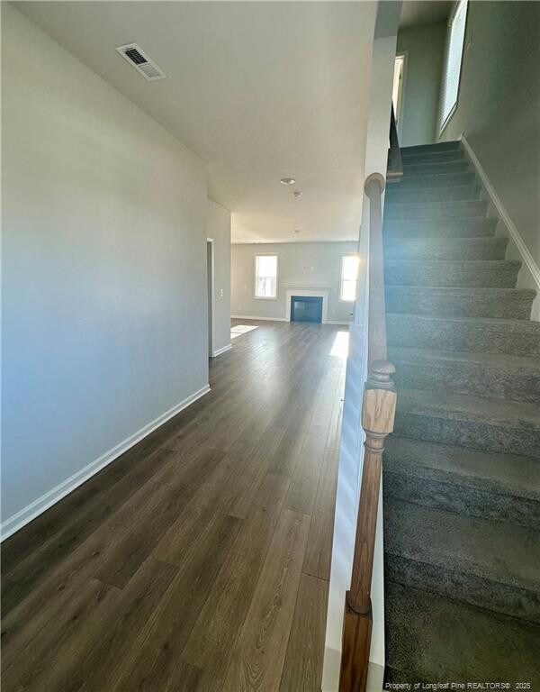 331 Brentmoor Dr, Raeford, NC 28376 - stairs with visible vents, baseboards, wood finished floors, and a fireplace