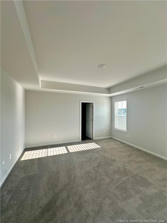 331 Brentmoor Dr, Raeford, NC 28376 - unfurnished room featuring baseboards, carpet, and a tray ceiling