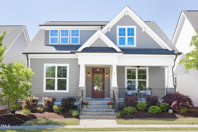craftsman house featuring roof with shingles and a porch