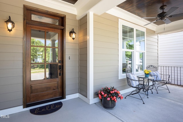 property entrance featuring ceiling fan and a porch