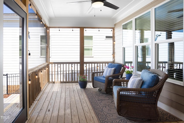 sunroom with a ceiling fan