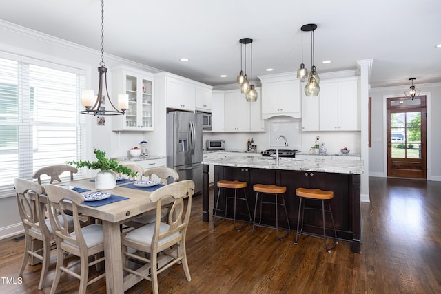 dining space featuring crown molding, baseboards, dark wood-style floors, and a toaster