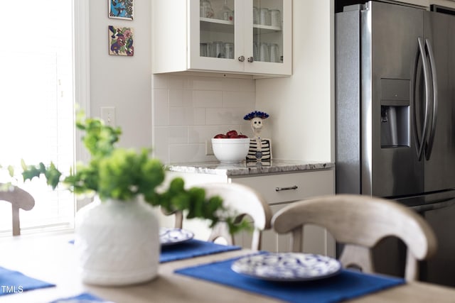 details with stainless steel fridge and tasteful backsplash