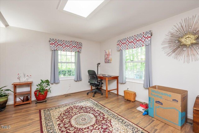 office area with wood finished floors, baseboards, and a healthy amount of sunlight