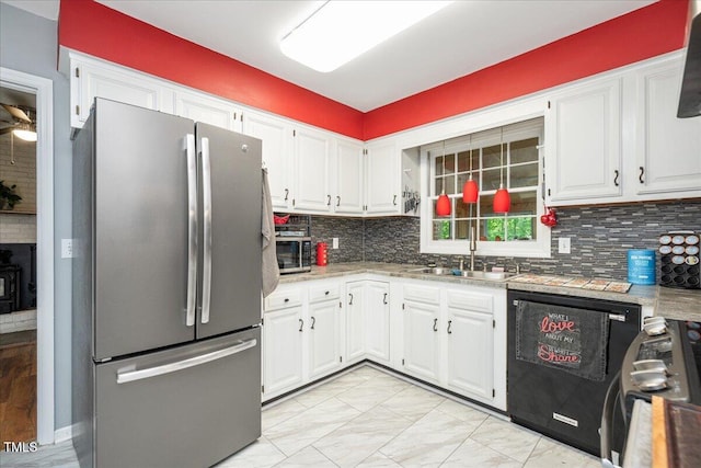kitchen featuring a sink, tasteful backsplash, white cabinets, and appliances with stainless steel finishes