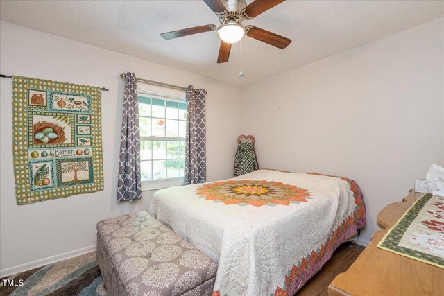 bedroom featuring baseboards and ceiling fan