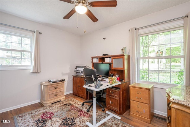 office with ceiling fan, light wood-style flooring, and baseboards