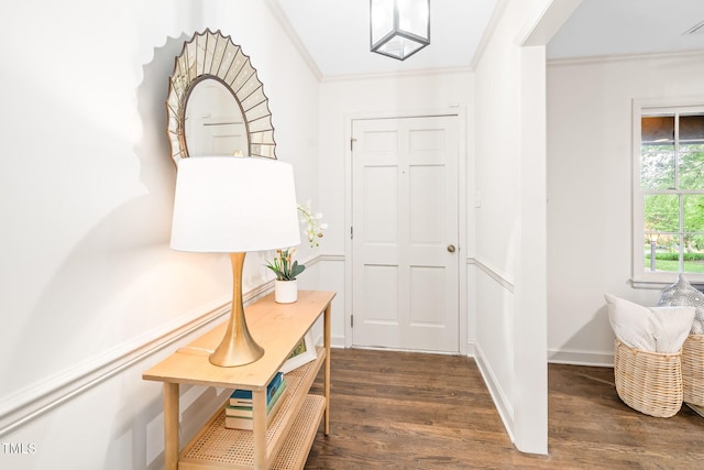 doorway to outside featuring crown molding, baseboards, and dark wood finished floors
